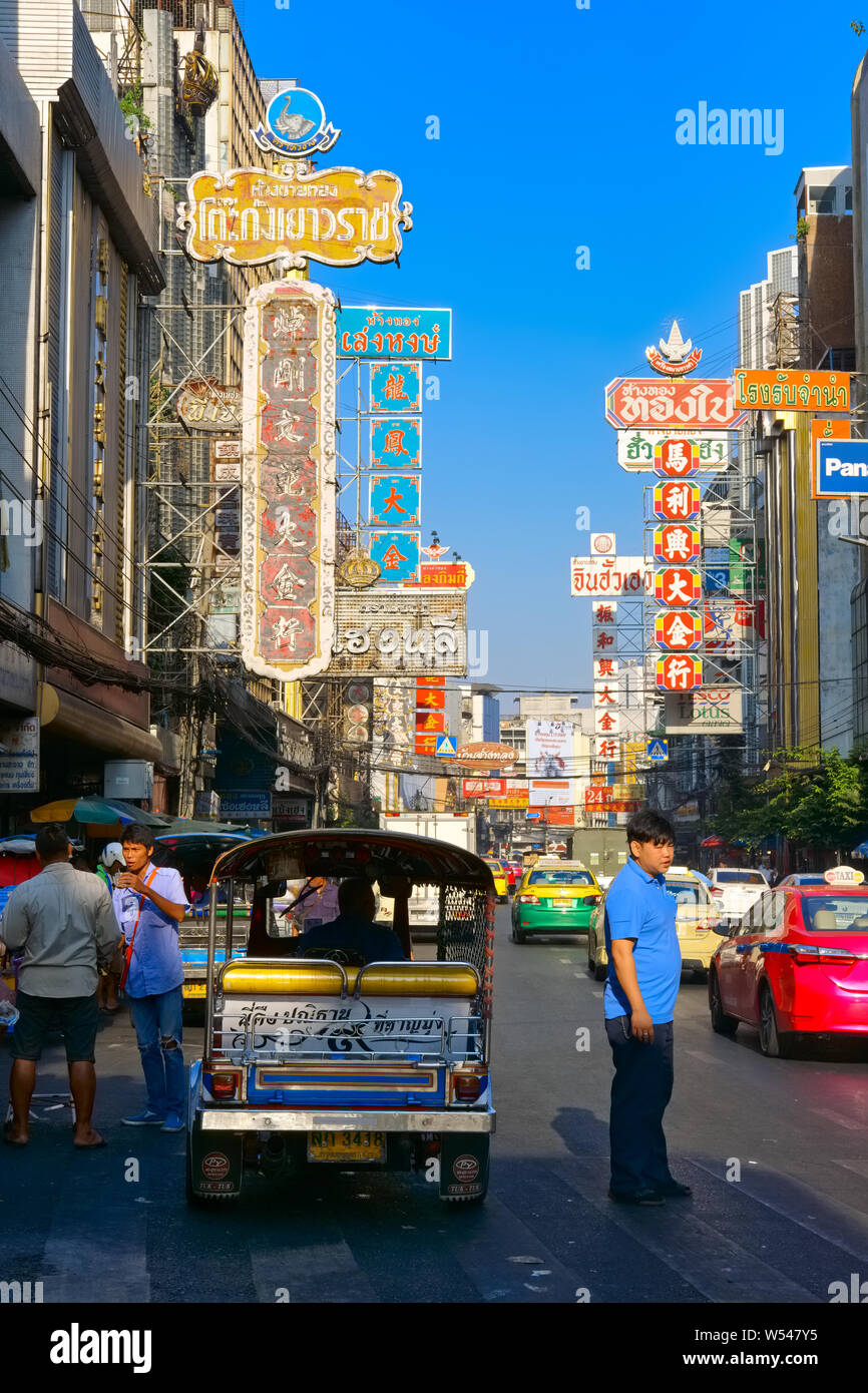 View of Yaowarat Road, the main thoroughfare in Chinatown, Bangkok, Thailand, with shop signs in Thai and Chinese Stock Photo