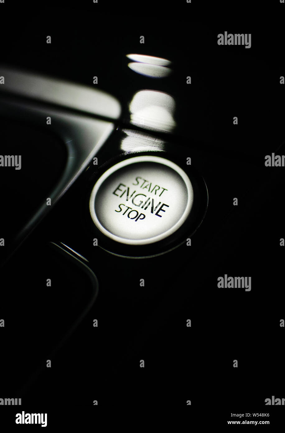 start/stop button surrounded by a glossy plastic interior of a modern car Stock Photo