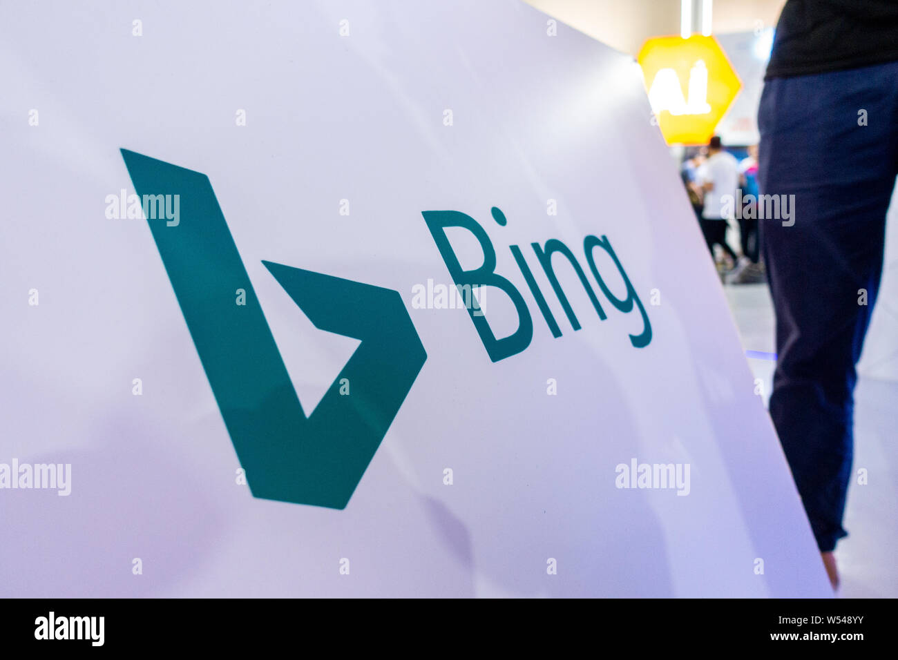 --FILE--A visitor walks past the stand of Bing search engine of Microsoft Corporation during the 2018 World Artificial Intelligence Conference (WAIC) Stock Photo
