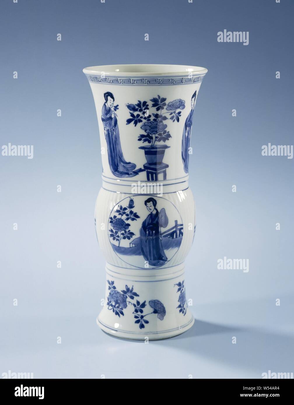 Beaker vase with Chinese la s and flower sprays Porcelain beaker vase with chinese la s and flower sprays porcelain vase with a ribbed ring thickening painted in underglaze blue on the thickening three medallions with a chinese lady long lines at a flowering peony in a fenced garden below a band with peony branches above the thickening twice two la s with a leaf in their hand separated by a flower pot a meander pattern on the edge marked on the bottom with the four character mark of emperor chenghua blue white anonymous china c 1680 c 1720 qing dynasty 1644 1912 kangxi period 1662 1722 porcelain material glaze image