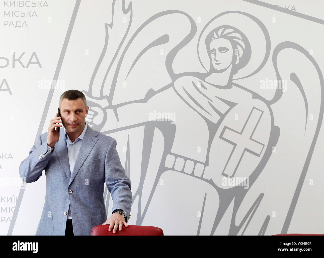 Kiev, Ukraine. 26th July, 2019. Mayor and former heavyweight boxing champion Vitali Klitschko talks on a mobile phone during a press conference in Kiev.Andriy Bohdan, Head of Ukrainian President Volodymyr Zelensky Presidential Office, sent a letter to Minister of the Cabinet Oleksandr Saenko asking him to submit a motion to dismiss Vitaliy Klitschko as head of Kyiv City State Administration, as local media reported. Credit: SOPA Images Limited/Alamy Live News Stock Photo