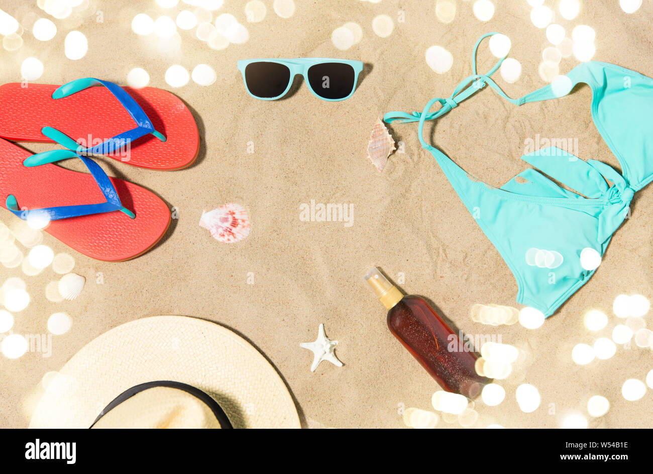 straw hat, flip flops and sunglasses on beach sand Stock Photo - Alamy