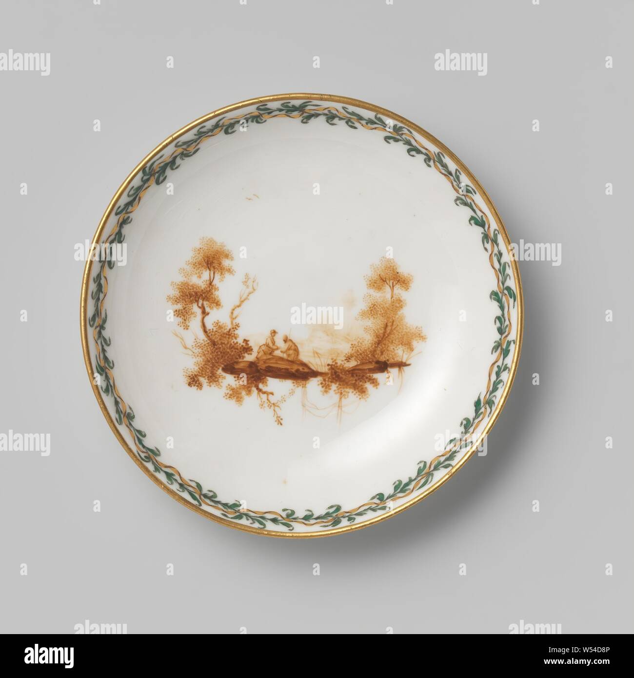 Saucer, painted with figures in landscapes, Porcelain saucer. Painted in sepia with figures in a landscape. Along the edges a winding ribbon in gold and brown, around which a green leafy branch winds., Manufactuur Oud-Loosdrecht, Loosdrecht, c. 1778 - c. 1782, porcelain (material), d 12.1 cm h 2.2 cm Stock Photo