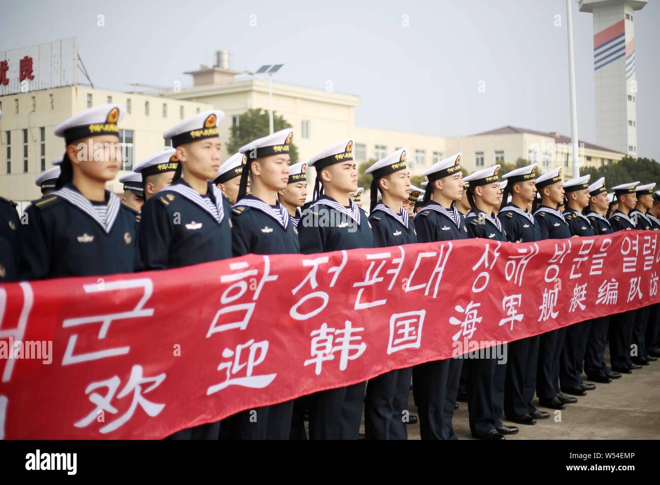 Chinese naval soldiers hold a banner to welcome South Korean navy at a ...