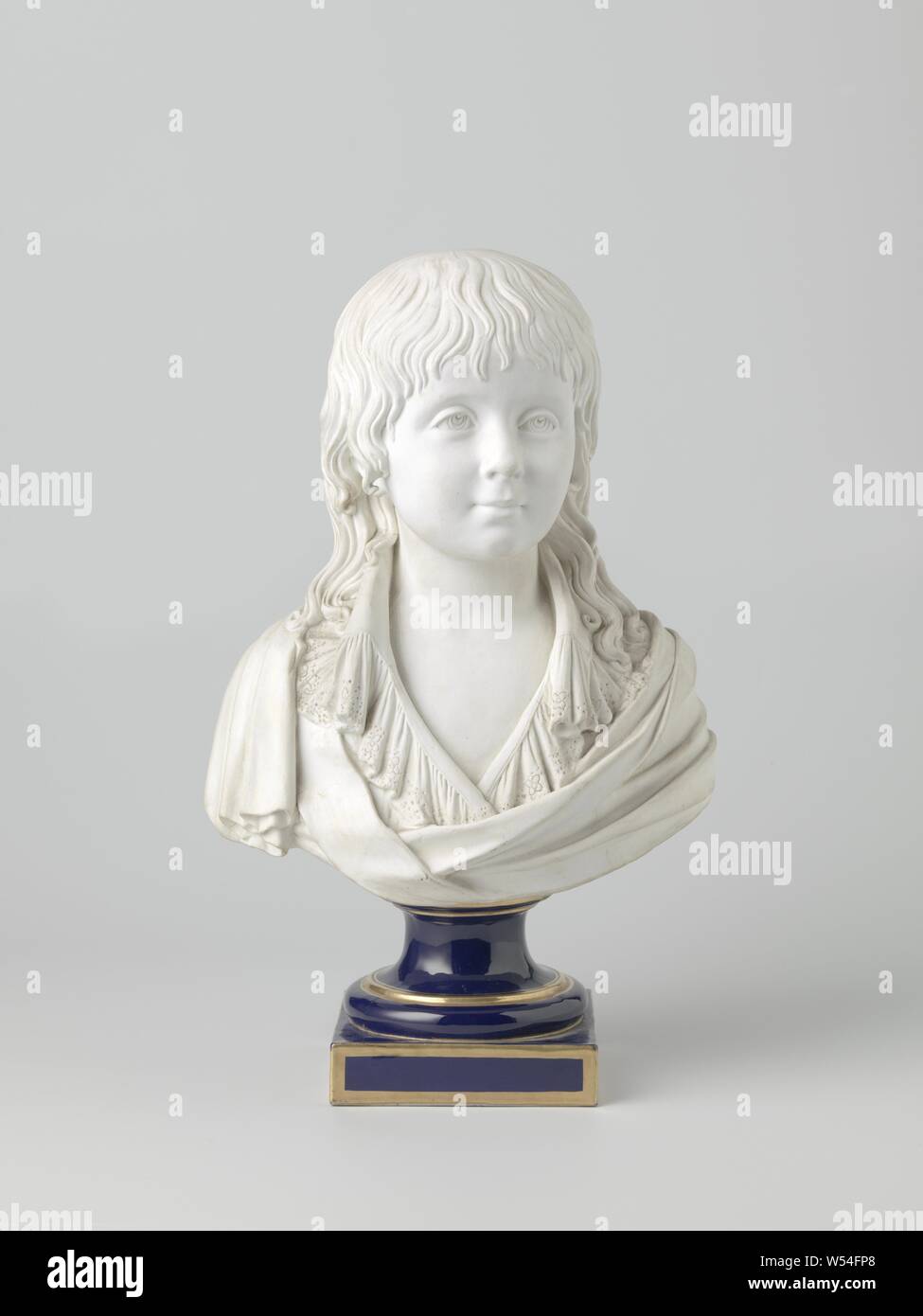 Bust portrait of Louis XVII in biscuit de porcelaine, as a boy of about 7 years with long locks up to the shoulders, wearing a chemisette with lace collar, on the chest left wide open, over it a sash from the right shoulder. The left shoulder is wrapped in a drapery drawn across the chest, mounted on a pedestal of dark ultramarine porcelain with golden piping. The mark is that of the manufacture royale de Sevres: jumbled, mirror-like L's, the loop of which, however, is not closed as usual, but open. This contains a small R, in addition a fashion designer brand, consisting of two crossed Stock Photo