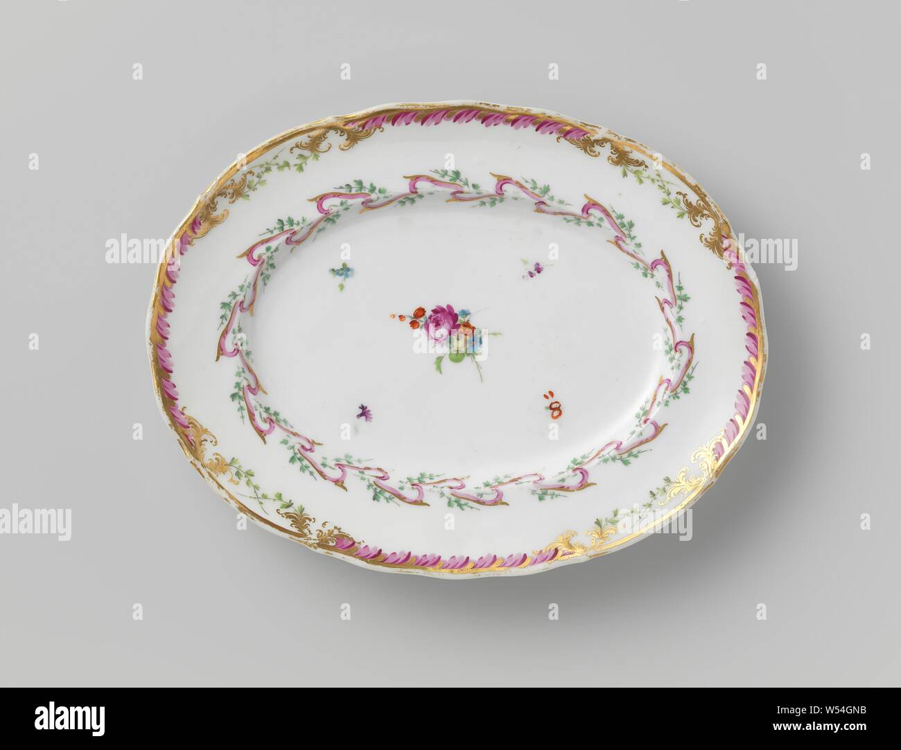 Saucer dish, associated with a service with garlanded ribbon motif with leaves, flower bouquets and sprinkled flower branchesm, originally two, associated with a porcelain service with garlanded ribbon motif in purple and gold with green leaves, flower bouquets and scattered flower branches. Borders slightly corrugated with decoration in gold with a purple leaf motif between which green crossed leaf motif. Marked: M.O.L. and Amstel. Remark: second dish was handed over in 1948 to the International Museum of Ceramics in Faenza., Manufactuur Oud-Loosdrecht, Amsterdam, 1780 - in or before 1820 Stock Photo