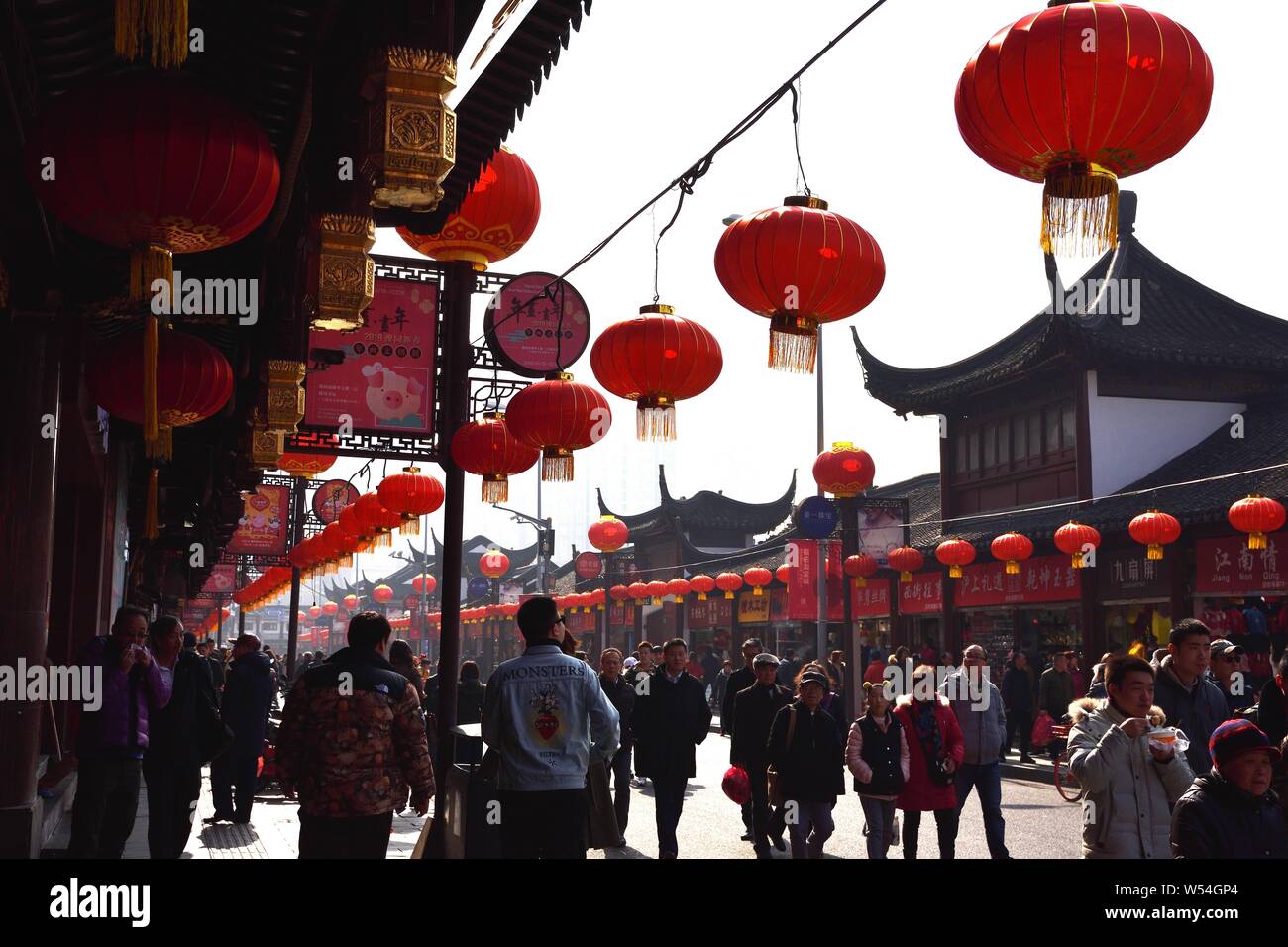 Tourists walk under traditional Chinese lanterns at Yu Garden or Yuyuan ...