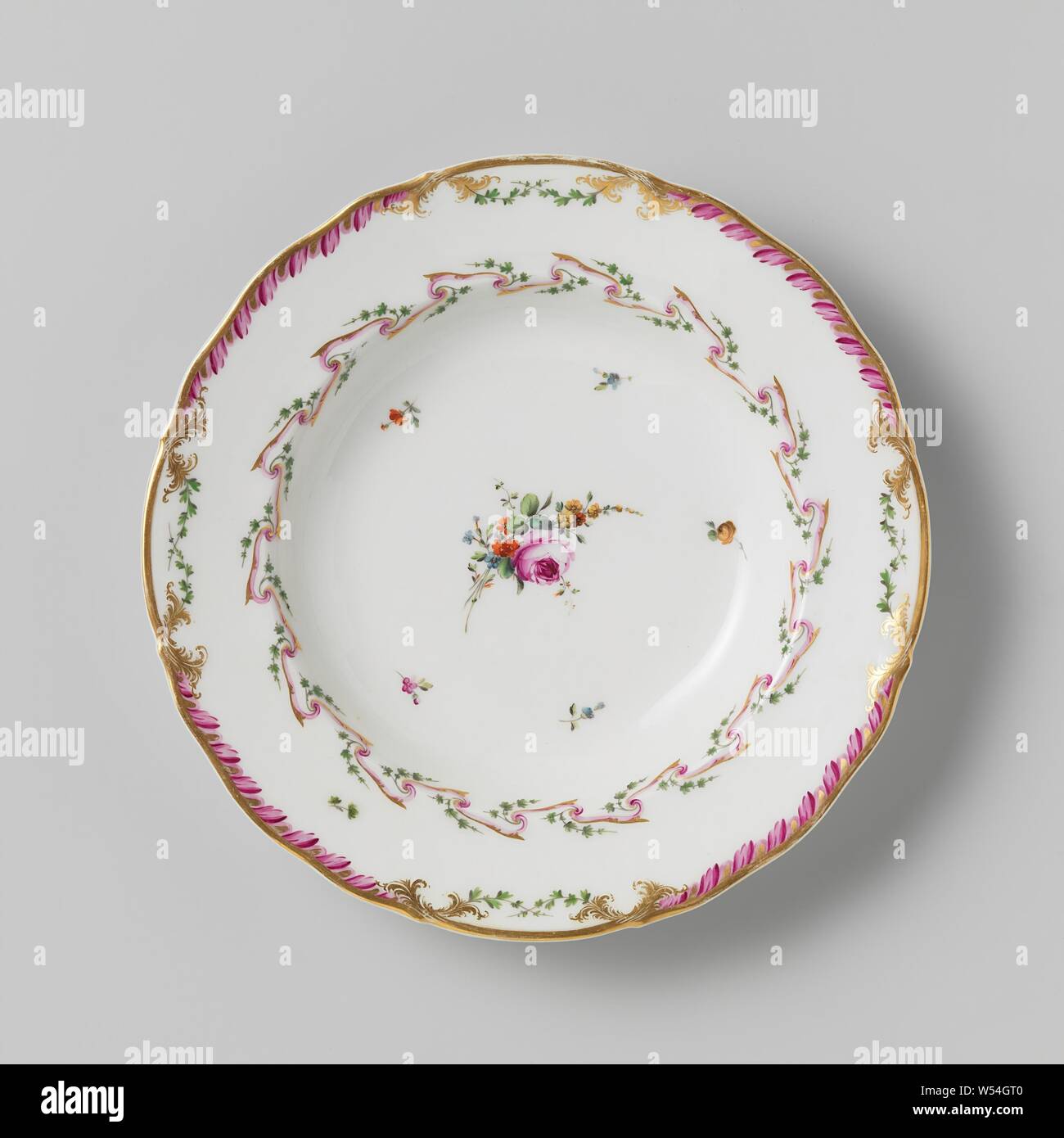 Plate, deep model, belonging to a service with a slung ribbon motif with leaves, flower bouquets and scattered flower branches, belonging to a porcelain service with slung ribbon motif in purple and gold with green leaves, flower bouquets and scattered flower branches. Borders slightly corrugated with decoration in gold with a purple leaf motif between which green crossed leaf motif. Marked: Mf. THE DIHL ET GUERHARD à PARIS. Series of eleven pieces., Dihl et Guerhard, Amsterdam, 1780 - in or before 1820, porcelain (material), h 4.2 cm × d 24.5 cm Stock Photo