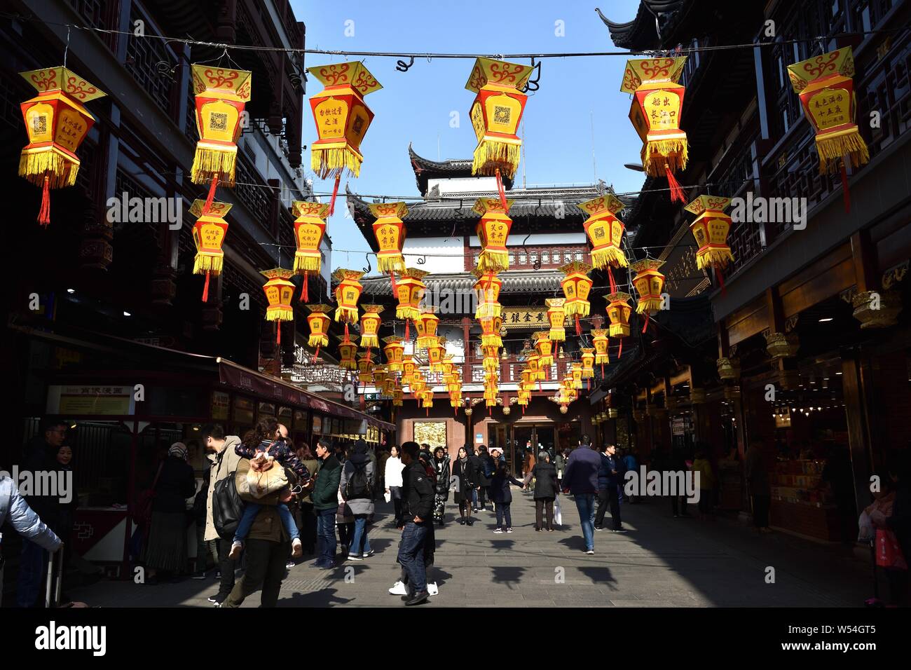 Tourists walk under traditional Chinese lanterns at Yu Garden or Yuyuan ...
