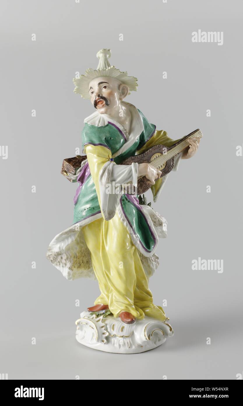 Pair of Malabars, Malabar, Figure of painted porcelain. The image represents a Chinese man (Malabar). The statue has a partially gilt round pedestal in rococo style and is mounted on a gilt bronze pedestal. The man plays a guitar and carries a brown chest on a string on his back. The image is marked. Originally the figure stood on a gilt bronze pedestal, cithern, mandolin, guitar, balalaika, vocal music, singing, making music, musician with instrument, anonymous, Meissen, 1748 - 1749, porcelain (material), bronze (metal), gilding, h 40.6 cm × w 17.3 cm × d 16.6 cm h 32.3 cm Stock Photo