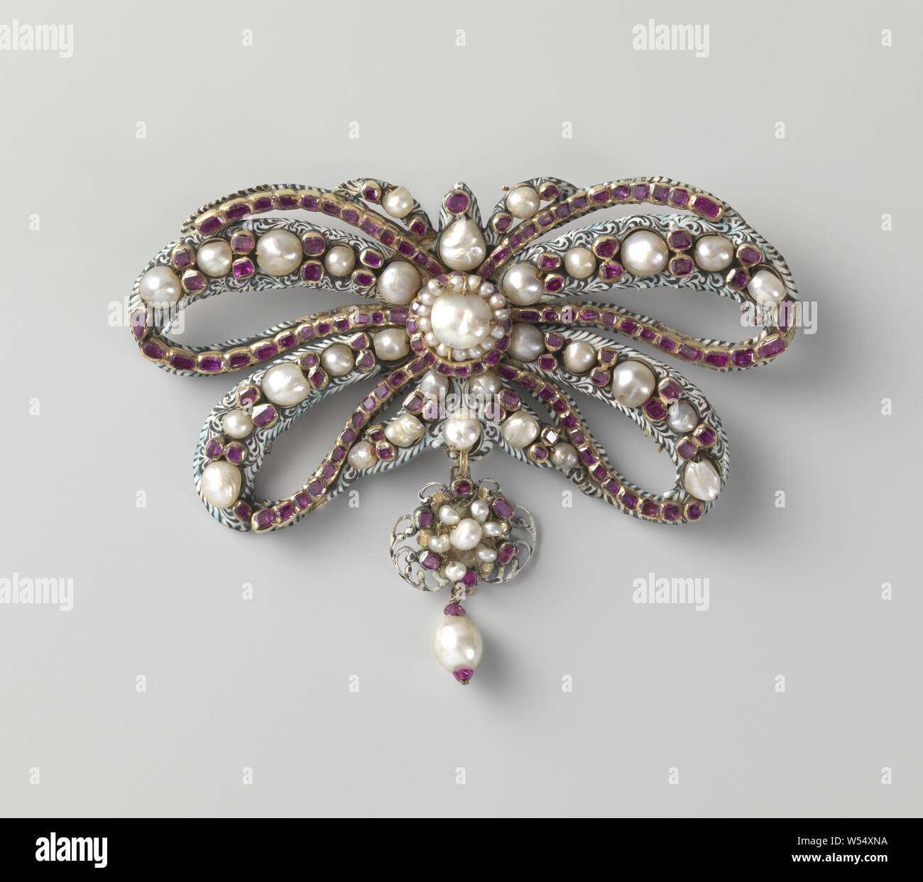 Bow brooch bow shaped brooch of enamelled gold. Set at the front with eight sets of pearls interspersed with two rubies and four sets of contiguous rubies. In the center a big pearl