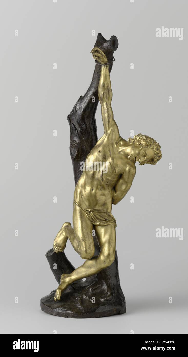 St Sebastian, Sebastiaan, Sebastiaan hangs with the right wrist tied to an upward protruding, truncated branch of an equally truncated tree trunk. The head hangs sideways to the right, the left arm is tied to the trunk on the back. The bent right leg rests with the toes against a low stump, the less bent leg hangs with the toes against the ground. St. Sebastian wears a beard and mustache. For shame he has a cloth held by a band, St. Sebastian, is tied to a tree or a pillar, is pierced by arrows (variant), Pietro Tacca (attributed to), c. 1610 - c. 1615, bronze (metal), touw, gilding, h 54.0 cm Stock Photo