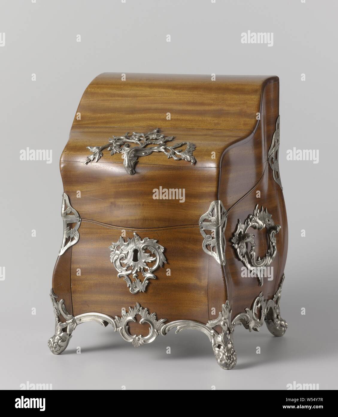 https://c8.alamy.com/comp/W54Y7R/cutlery-canteen-cutlery-case-the-rectangular-mahogany-chest-with-high-rising-rear-has-multiple-arched-sides-protruding-corner-posts-and-a-lid-with-silver-hinges-it-rests-on-four-cast-silver-legs-in-the-shape-of-a-tall-flower-branch-emerging-from-the-legs-run-along-the-underside-of-the-case-with-cast-silver-edges-those-on-the-front-are-made-up-of-two-horizontal-c-volutes-on-either-side-of-an-asymmetrical-open-worked-cartouche-of-two-standing-c-volutes-crowned-by-a-foam-edge-that-on-both-sides-from-two-horizontal-c-volutes-on-either-side-of-a-tilted-cartouche-comparable-to-the-one-W54Y7R.jpg