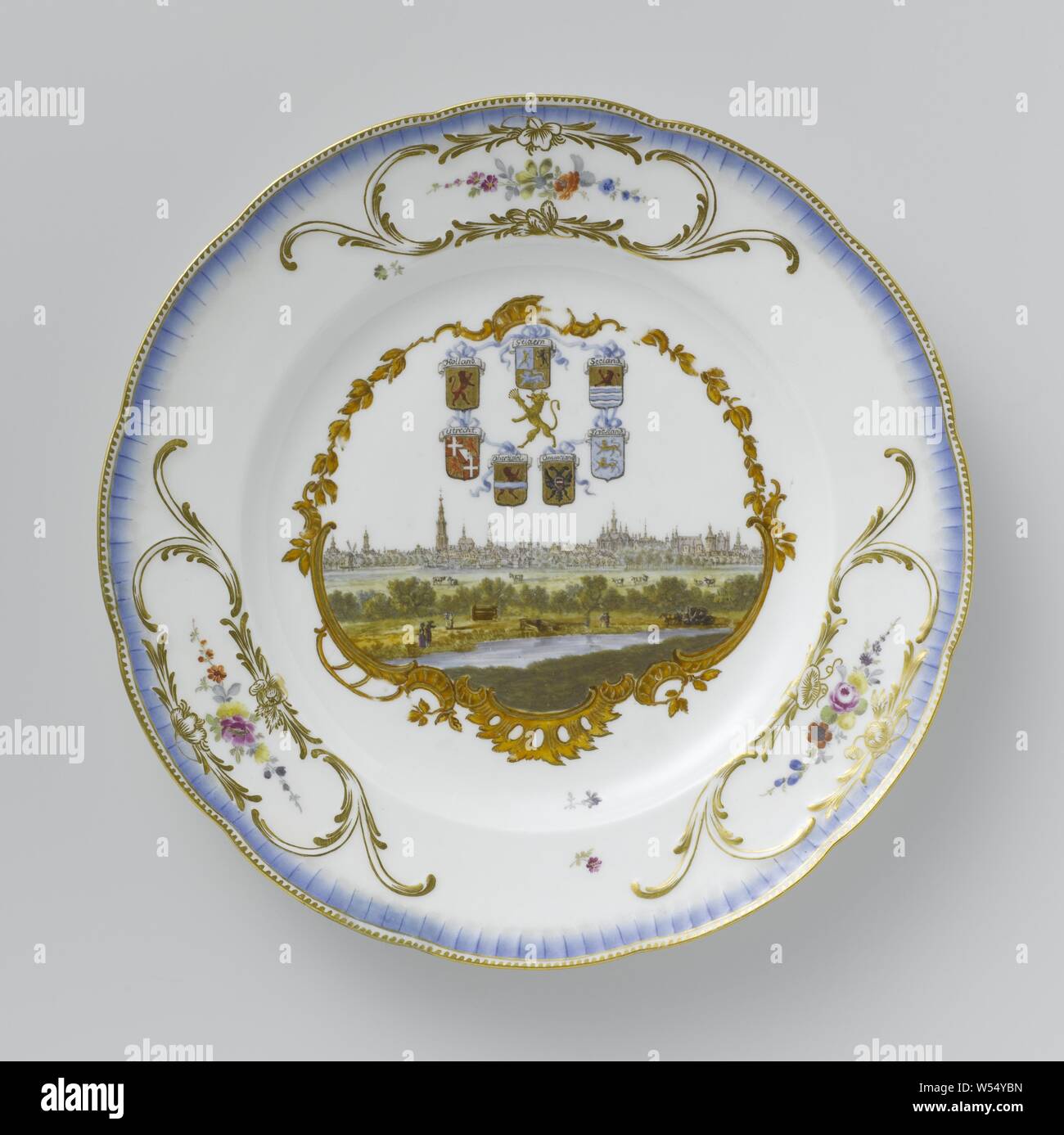 Seven plates from the service of Stadtholder William v Plate from the Stadtholder Service, with a view of The Hague and the seven coats of arms of the United Netherlands Plate from the stadholder's service, multicolored painted with a face on it The Hague and the seven arms of the United Netherlands, Round plate of painted porcelain. The border is scalloped and has three cartouches embossed with gold, including a multi-colored flower garland. A blue, ribbed piping runs along the edge. The mirror is painted with a rocaille cartouche with a topographic face inside, described on the back as' 'The Stock Photo