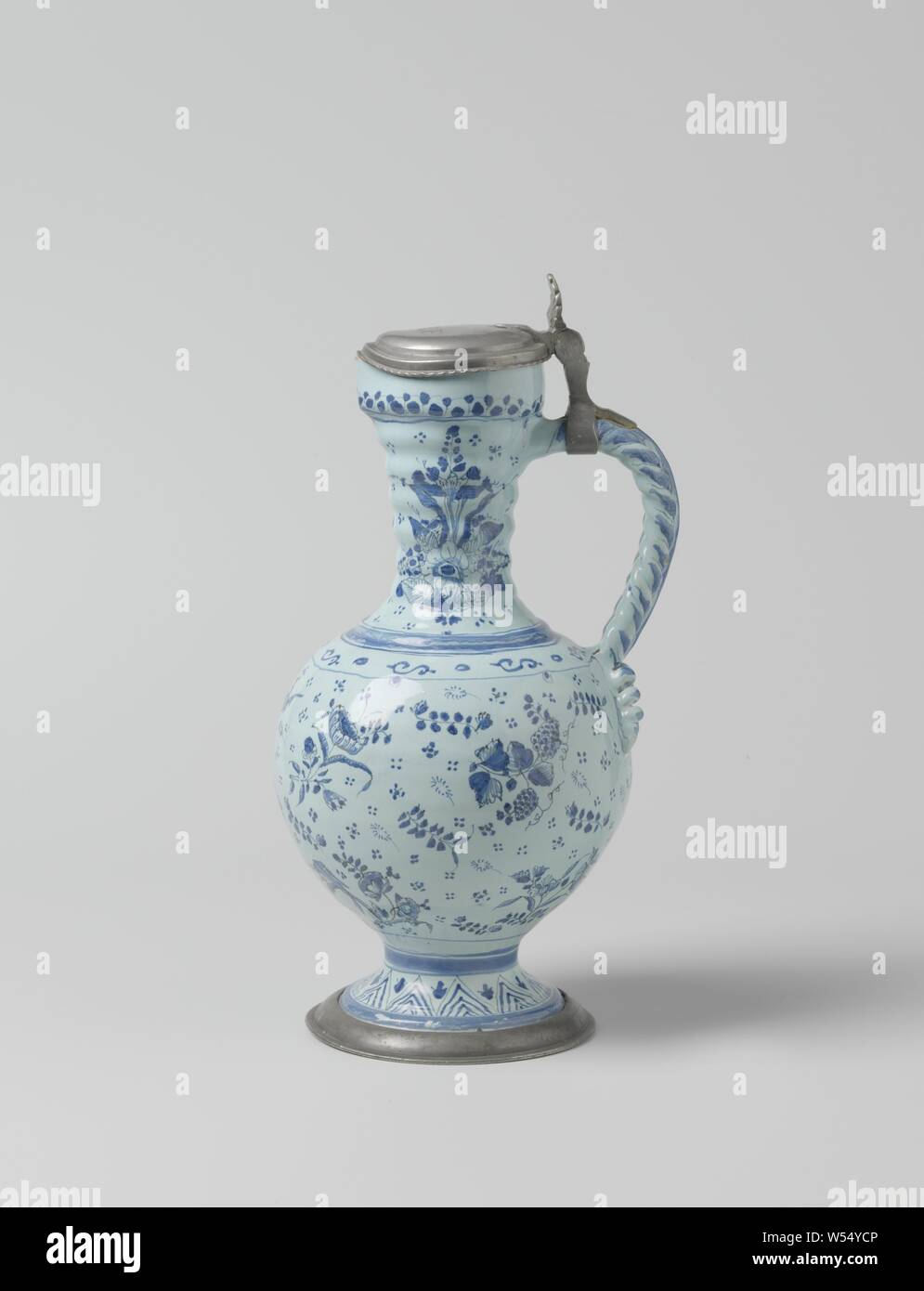 Jug with pewter lid, painted with scatter motif, Jug of blue painted faience, with a blue ground, a pewter foot ring and a pewter lid. The jug has a foot, a spherical belly and a cylindrical ribbed neck. The ear is braided and ends in two curls on the belly. On the jug is a scatter motif painted consisting of flowers, birds, branches with leaves and fruits, a peacock and rosettes. In the top of the lid are the letters M.C.H. engraved. The jug is marked., Johannes Polts, Hanau, c. 1700, earthenware, tin glaze, h 30.8 cm h 27.8 cm w 16.2 cm d 14.5 cm Stock Photo