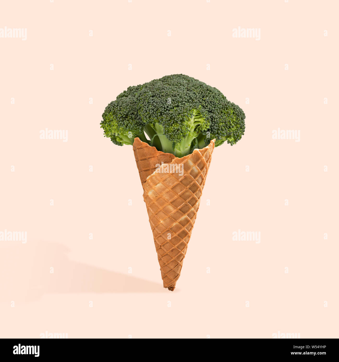An alternative view of food. Natural icecream of broccoli on coral background. Negative space to insert your text. Modern design. Contemporary art. Creative conceptual and colorful collage. Stock Photo