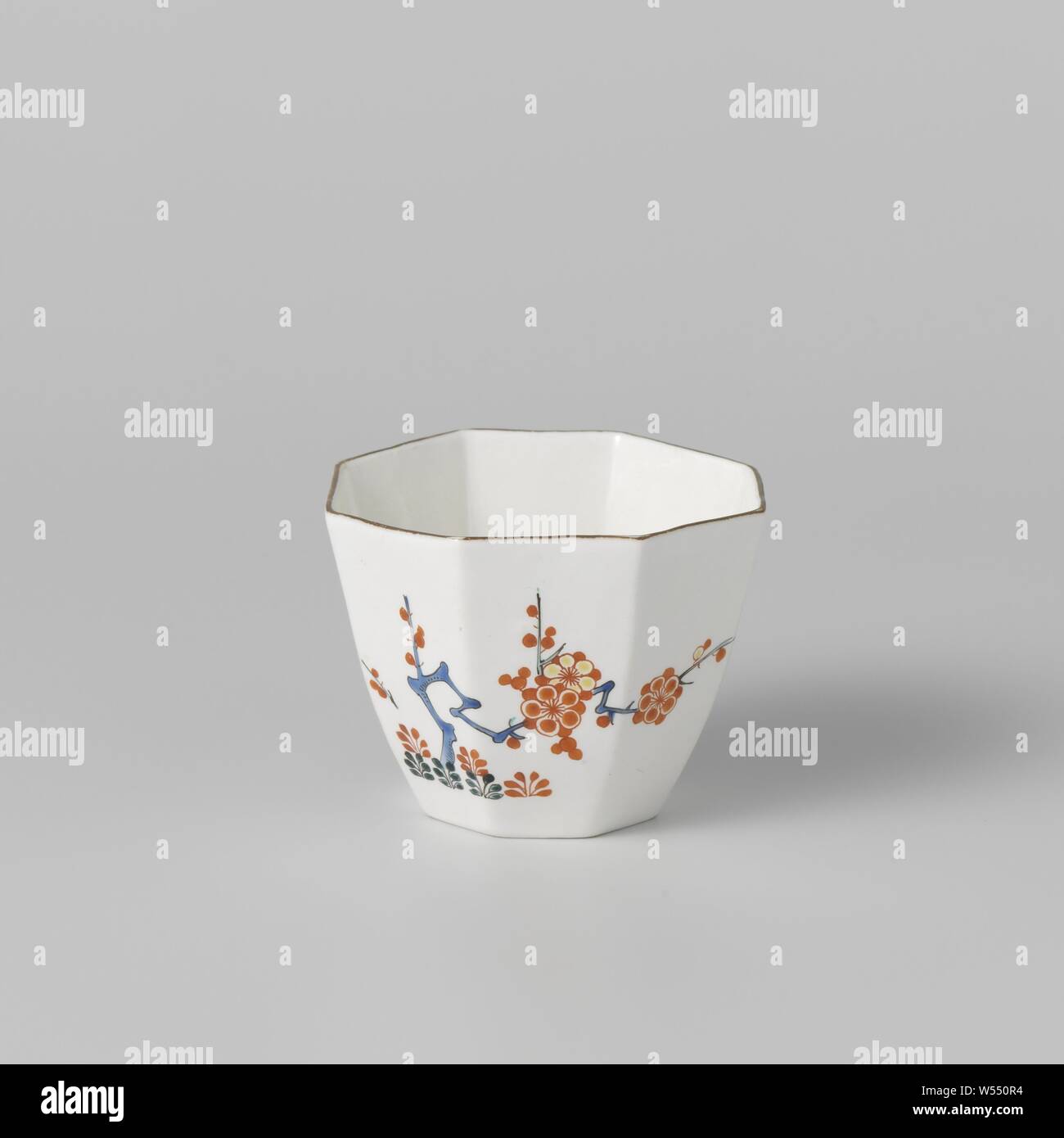 Cup with quail and flowering plants, Octagonal cup of soft-paste porcelain (pate tendre), painted on the glaze in blue, red, green, yellow and black. The outer wall with quail and insects (butterfly) on flowering plants (prunus). Brown border. Marked on the bottom with the handset. The head is in the style of the Japanese Kakiemon porcelain., Chantilly, c. 1725 - c. 1749, porcelain (material), soft-paste porcelain, glaze, vitrification, h 5.7 cm d 7.7 cm d 4.3 cm Stock Photo