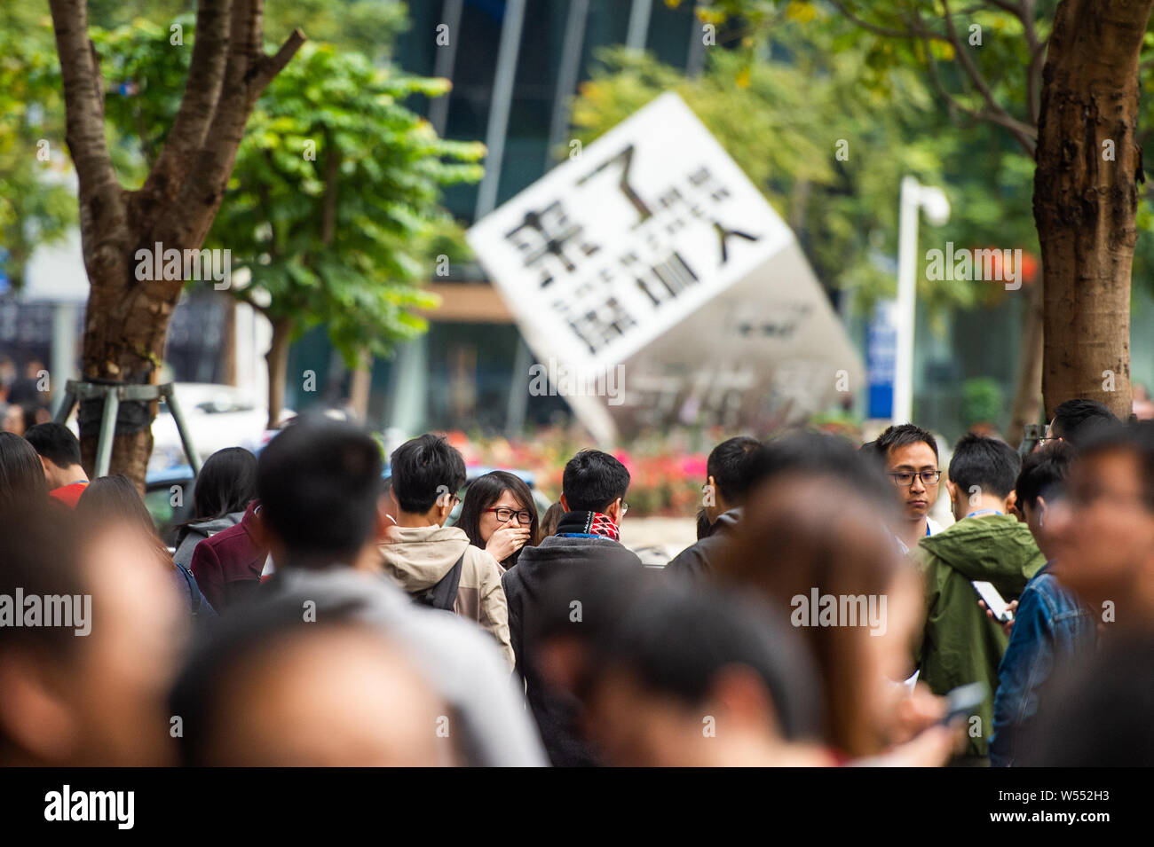 Employees of Chinese Internet giant Tencent queue up to get hongbao (red envelopes with lucky money) at the headquarters of Tencent in Shenzhen city, Stock Photo