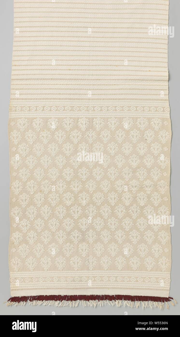 Buffet runner made of pure cotton, decorated with woven relief motifs with a flower field and narrow stripes, dark red beads are strung in the fabric fringes., Roemenie, 1885 - 1915, cotton (textile), h 264.0 cm × w 50.0 cm Stock Photo