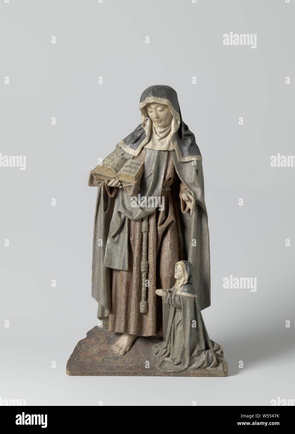 Saint Claris with founder, anonymous, Southern Netherlands, c. 1500 - c. 1525, wood (plant material), h 37.5 cm × w 20 cm × d 7 cm Stock Photo