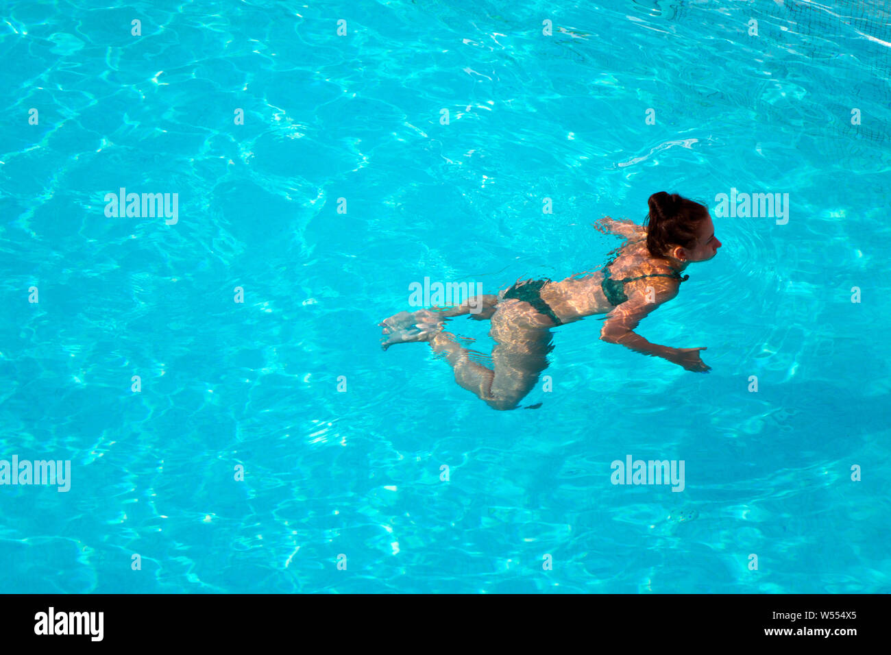 view down on a woman swimming Stock Photo