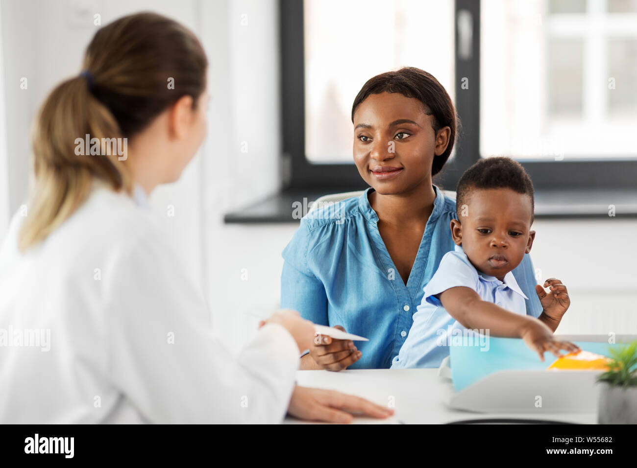 happy mother with baby son and doctor at clinic Stock Photo - Alamy