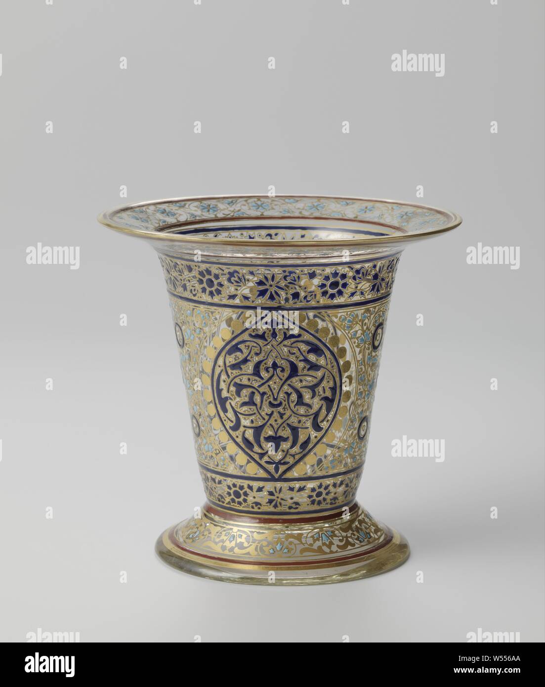 Vase Vase with orienting motifs, Vase with curved foot edge, conical foot, funnel-shaped body, flat and protruding edge. Decoration in white, brown, dark and light blue and gilt in orienting motifs. Marked on the bottom in white enamel with the monogram JLW (Joseph and Ludwig Wien), ornaments, art, J. en L. Lobmeyr, Bohemen, c. 1870 - c. 1880, glass, gilding, h 13.4 cm × d 14.5 cm d 10.3 cm Stock Photo