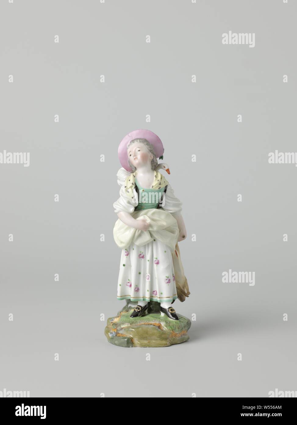 Girl with a bird in a basket and a rabbit, Porcelain image, painted on enamel and gold enamel. The image represents a girl walking with a bird (goose?) In a basket on her back and a dead rabbit in her hand. She is holding her over socks with her right hand. Marked on the bottom with the wheel, HM and N4., Höchst, c. 1767 - c. 1775, porcelain (material), glaze, gold (metal), vitrification, h 17 cm × w 7 cm × d 6.2 cm Stock Photo
