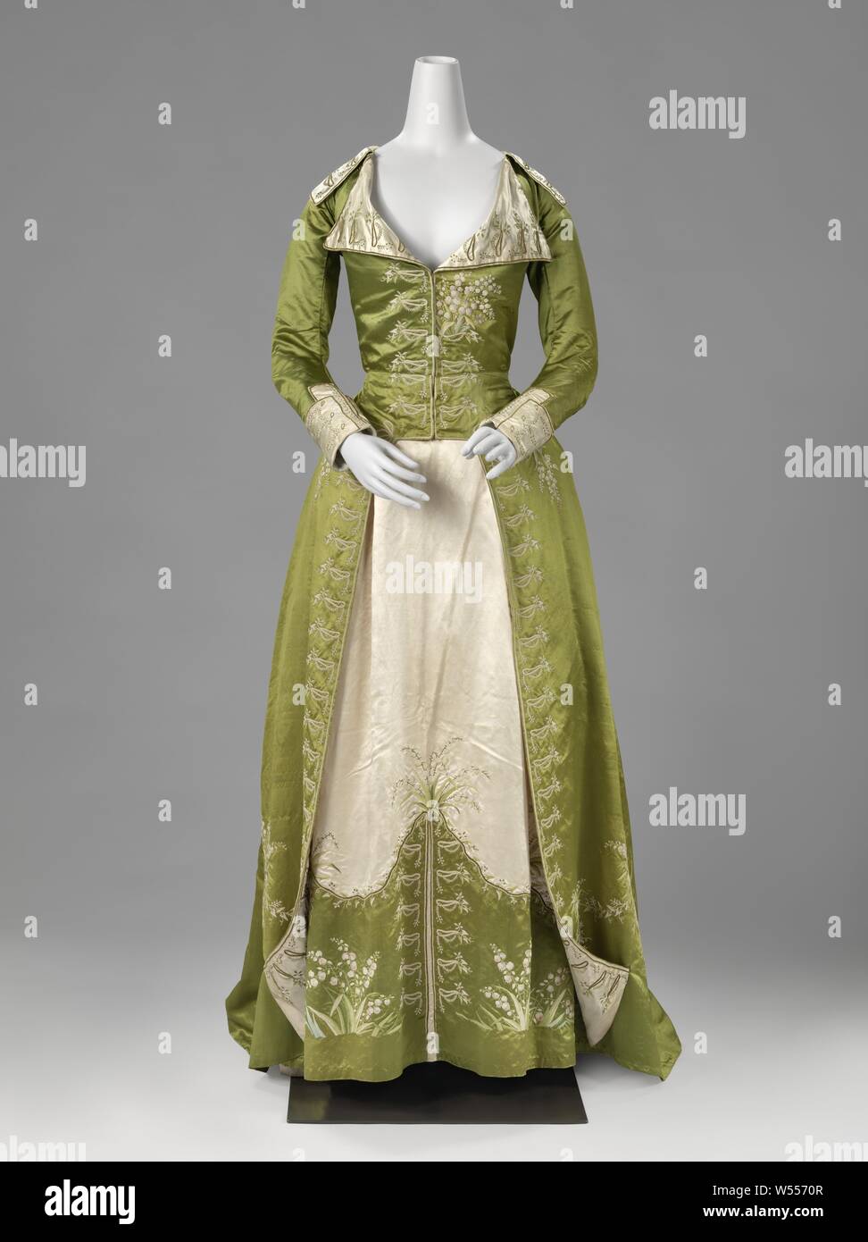 Redingote or Great-Coat Dress Redingote or frock, frock or 'redingote' made of moss green and soft pink silk, consisting of a frock with open skirt (a) and a skirt (b) embroidered with lily of the valley. This dress was worn on October 18, 1881 by Louise Six (1862-1934) for a tableau vivant on the occasion of the silver wedding of her uncle and aunt Six-Teding van Berkhout. The dress was probably from the family of Louise's mother, d'Ablaing van Giessenburg., anonymous, Netherlands, c. 1786 - c. 1789, silk, satin, embroidering Stock Photo