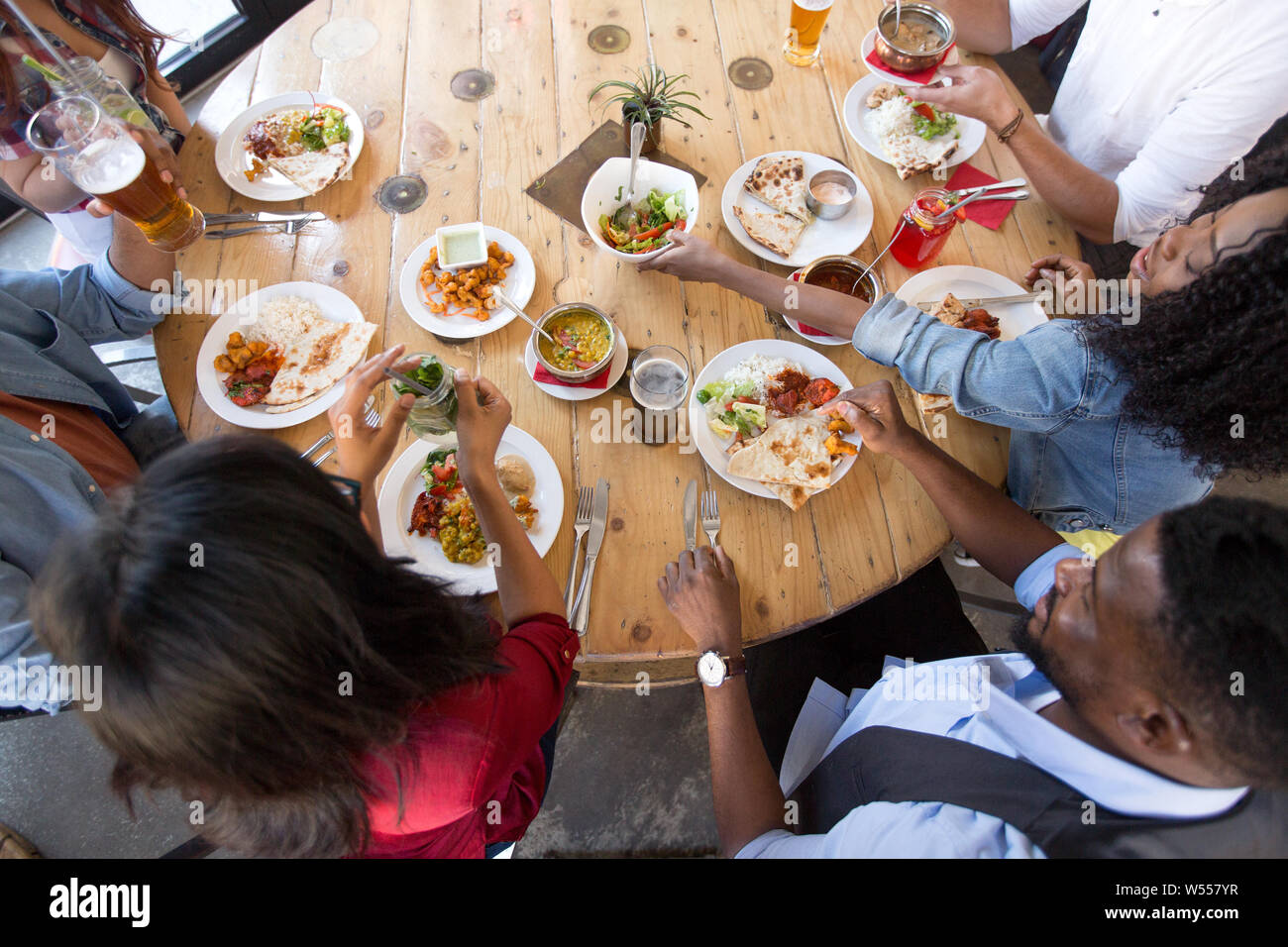international friends eating at restaurant Stock Photo