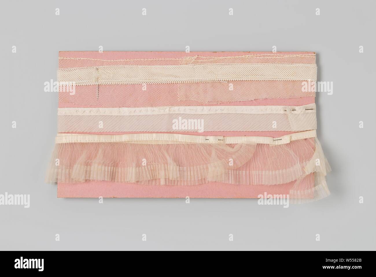 Three white ruffles wound around a pink piece of cardboard, Three white ...