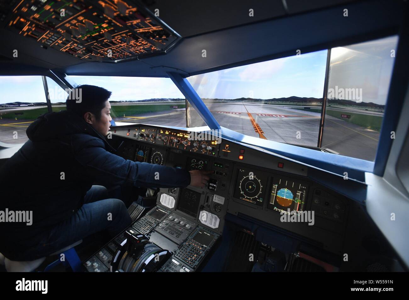 Chinese farmer Zhu Yue tests in the cockpit of a full-scale replica of Airbus A320 jet plane built by him at an open space in Kaiyuan city, northeast Stock Photo