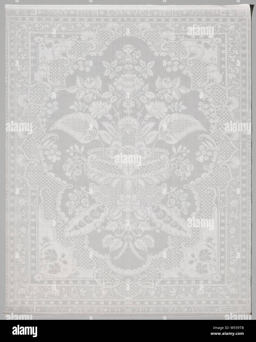Napkin of linen damask with a lace pattern, White linen damask napkin, decorated with 'lace' pattern and woven AGT BESIER ANNO 1736 and GHD IORDENS ANNO 1736., anonymous, Southern Netherlands (possibly), 1736, linen (material), damask, h 114 cm × w 88 cm Stock Photo