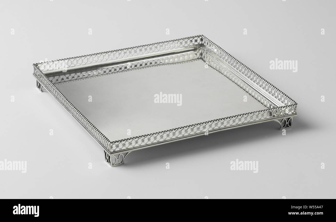 Serving tray, square, with raised edge, the square blade has a raised flat edge. The upright wall is sawn open with rosettes connected by rosettes, which are engraved on the outside. It is closed at the bottom by a stepped profile frame and at the top by a pearl edge. The leaf rests on four slightly indented legs. Its straight walls have a curved interior and are sawn open with ovals. (Catalog Amsterdam Gold and Silver, catalog number 120), Reynier Brandt (attributed to), Amsterdam, 1782, silver (metal), h 3.3 cm × w 25.4 cm × d 25.4 cm × w 734.0 Stock Photo