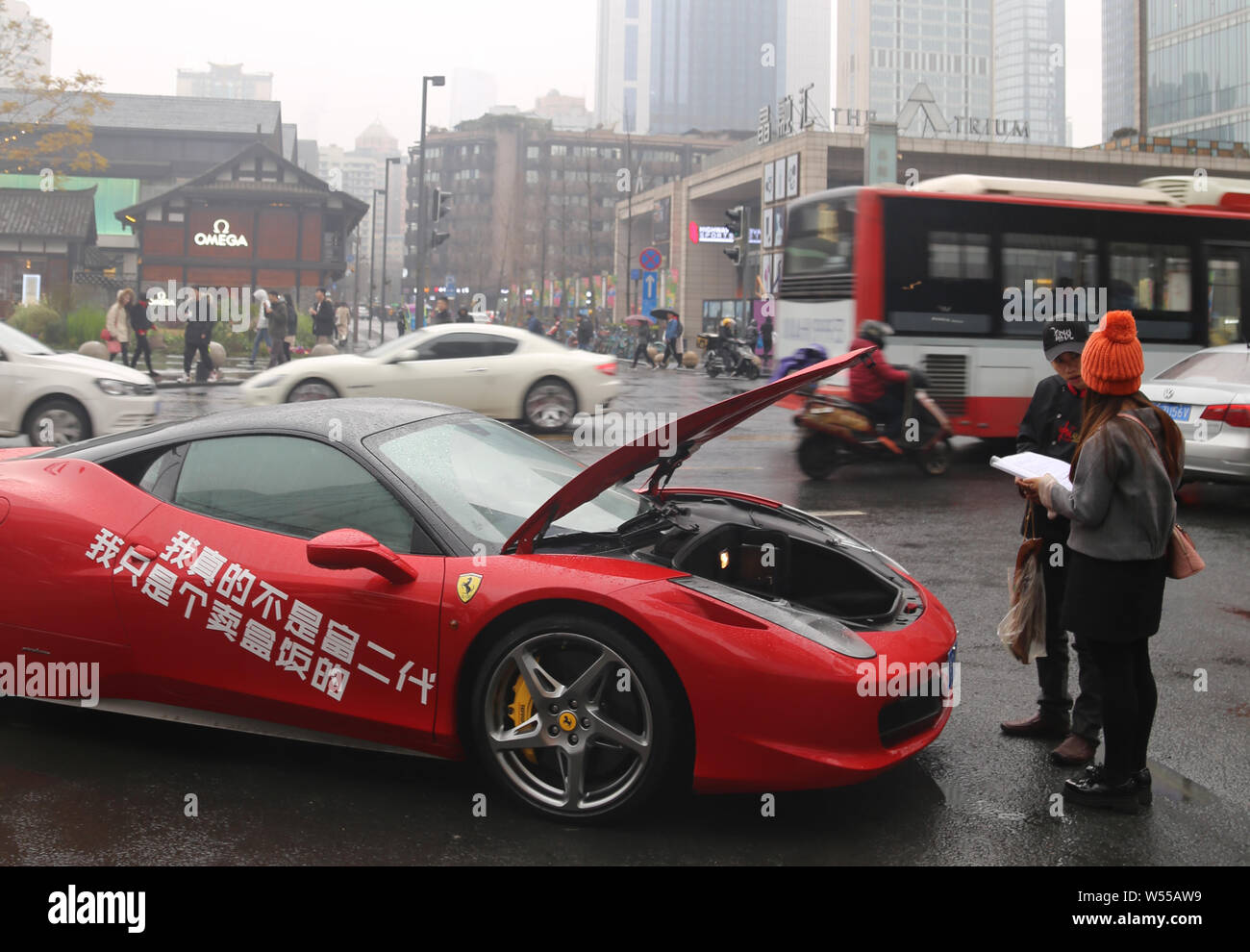A food store owner drives a luxury Ferrari sports car to deliver meals to customers in downtown Chengdu city, southwest China's Sichuan province, 24 F Stock Photo
