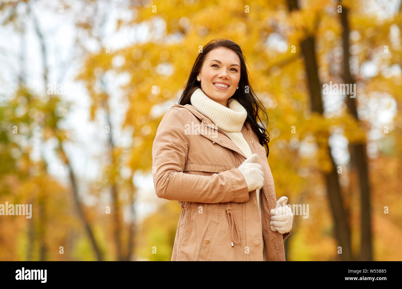 beautiful happy young woman smiling in autumn park Stock Photo - Alamy