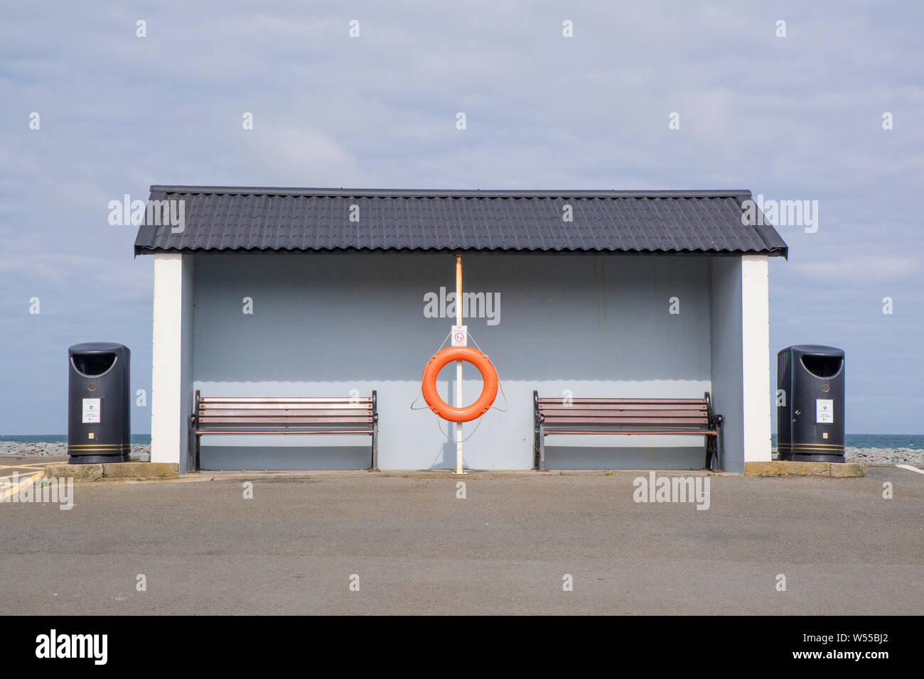 A rather dull weather shelter at a seaside resort overlooking a carpark, Britain, UK Stock Photo