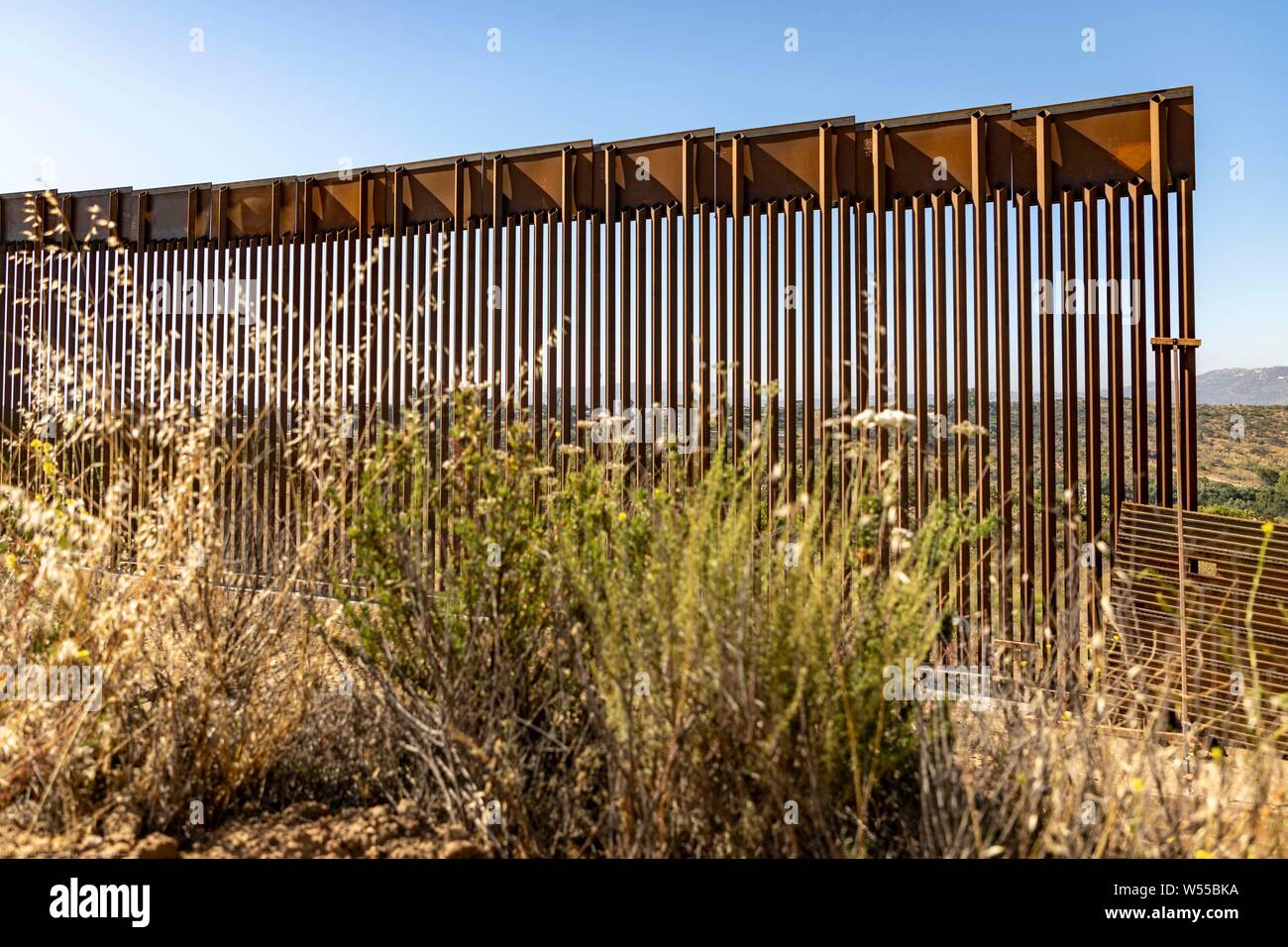 A section of replacement border wall along the southern border with Mexico June 19, 2019 near Tecate, California. The replacement was authorized under the Obama administration and is in the process of being completed. Stock Photo