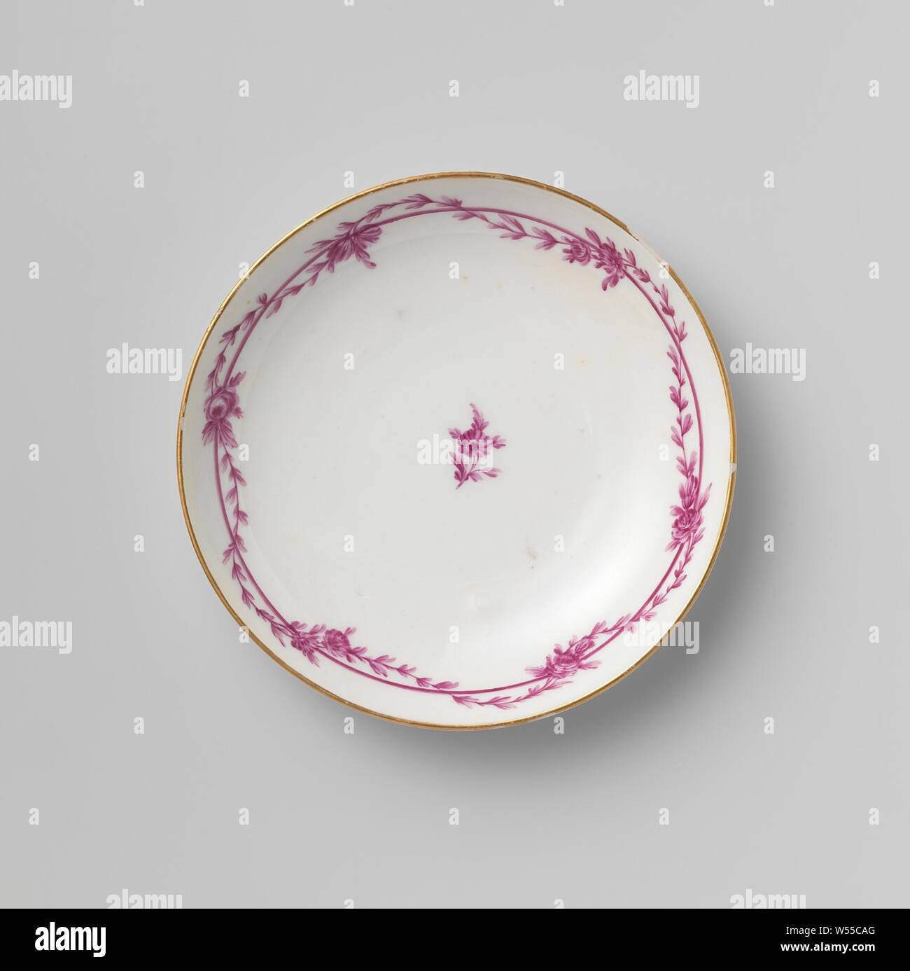 Saucer, Porcelain saucer, decorated in beet red with a flower and leaf garland flung around a continuous band. The edges are gilded. Decorated with beetroot flowers. Signature M.O.L. with star in underglaze blue., Manufactuur Oud-Loosdrecht, Loosdrecht, c. 1780, porcelain (material), d 12.1 cm × h 2.2 cm Stock Photo
