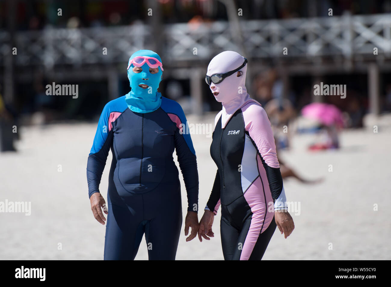 Chinese women wearing facekini visit a beach resort at the Dadonghai