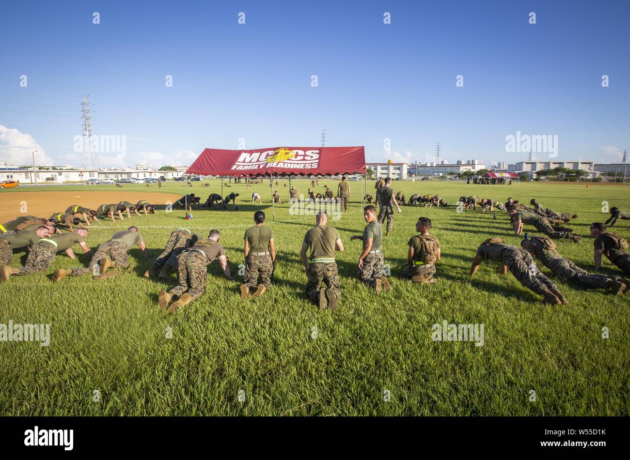 Marines with Marine Wing Headquarters Squadron 1 perform various exercises during their annual Battle Skills Test on Camp Foster, Okinawa, Japan, July 26, 2019, July 26, 2019. Every Marine must be physically fit, regardless of age, grade, or duty assignment. This event provided Marines an opportunity to physically train and push themselves while building camaraderie within the unit. The annual assessment covers a variety of categories including: basic infantry skills, first aid, communications, history, leadership, and the Uniform Code of Military Justice. Being proficient in these skills ensu Stock Photo