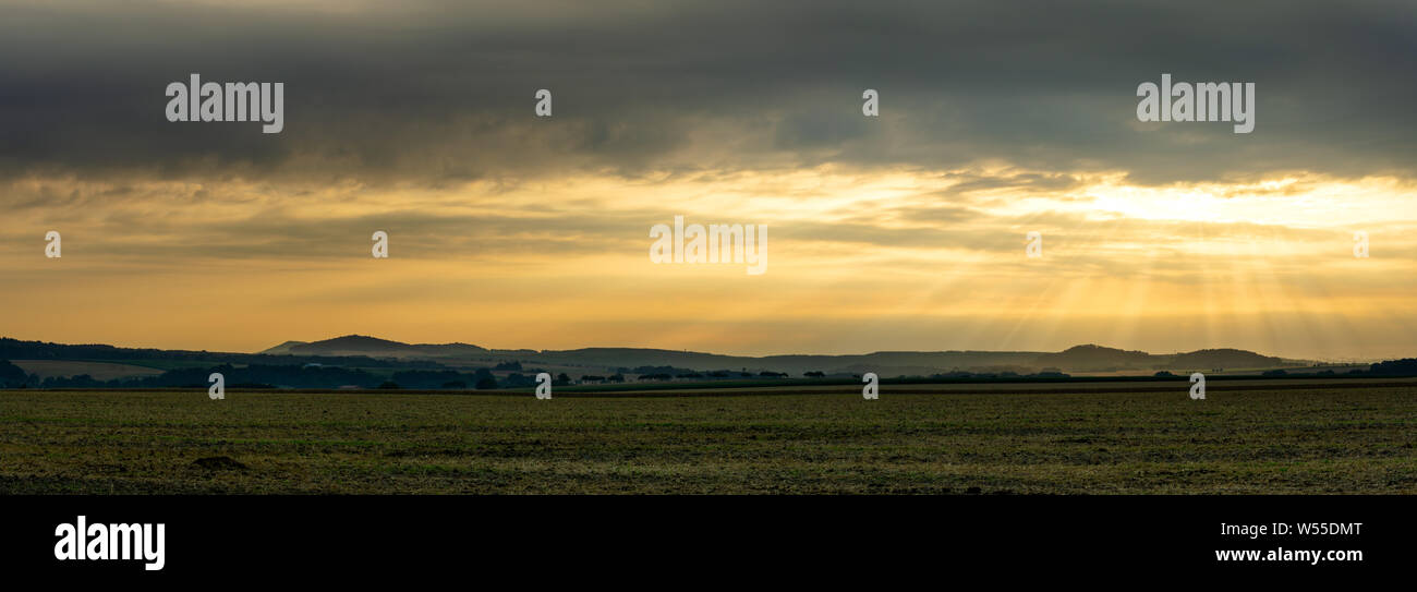 Scenic view on rural landscape in golden morning sunrise with sun rays breaking through the clouds. Upper Lusatia Bernstadt Germany Stock Photo