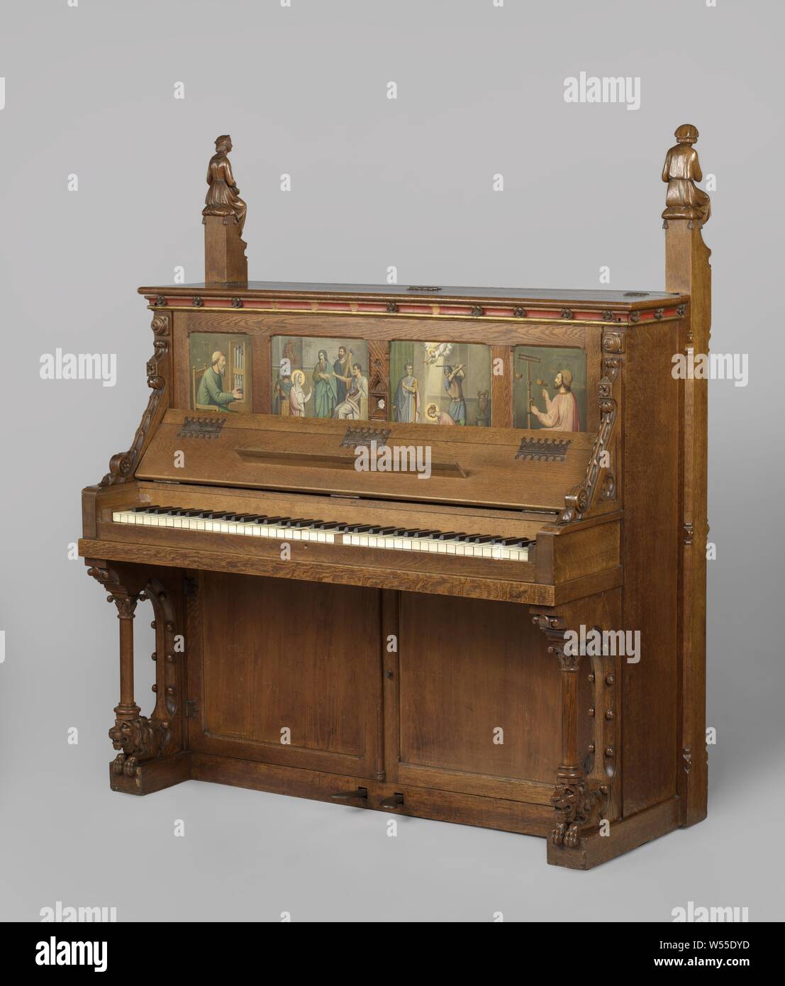 Music cabinet and piano with a relic or St Cecilia Music cabinet and piano with a relic or St Cecilia Piano whose cabinet is partly painted in oak and pine with colors and gold on the front a rear glass placed relic, Piano, of which the oak and pine cabinet is partially painted in colors and gold. The pillars bearing the keyboard rest on lying lions coming out of the cupboard, and the two high corner posts are crowned by the figures of a flute player and a citizen player, with the faces of Cuypers and his wife Antoinette. On both sides of the relic of St Cecilia placed behind glass, painted Stock Photo