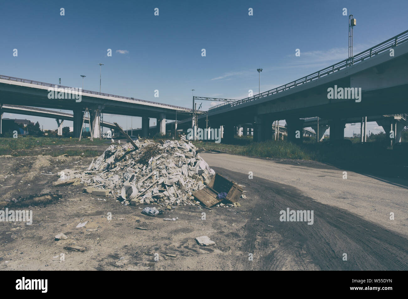 Illegal garbage dump near highways in urban industrial zone Stock Photo