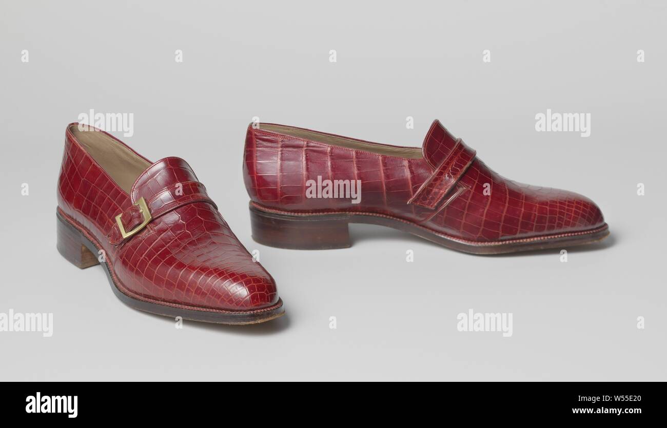 Pair of shoes (oxfords) Molé of red crocodile leather with gold-colored buckle, Left molar of red crocodile leather with gold-colored buckle. Model: a 1.5 cm wide belt is placed over the tongue, which is closed on the outer side of the shoe by means of a gold-colored buckle. A small elastic strip under the tongue to facilitate entry. The forefoot is lined with natural-colored cotton, the rest of the shoe with beige lacquered leather. Leather insole with golden print. Flat leather heel. Embellishment: the seam on the heel is camouflaged by a narrow strip of crocodile leather. Address (on Stock Photo