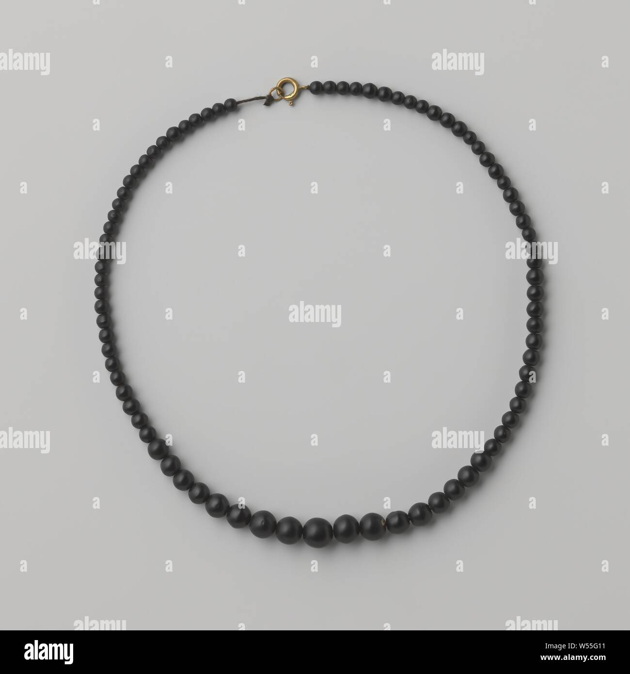 Mourning necklace with round beads of black glass, Mourning necklace with round beads of black glass with a gold colored clasp with spring ring. The beads are smaller towards the closure., anonymous, Europe, c. 1880 - c. 1900, glass, silver (metal), basting, c 46 cm × d 1 cm Stock Photo