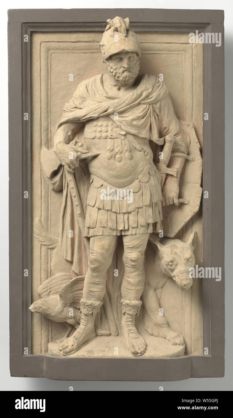 Mars, The god stands head-on, the head slightly to the right, in full armor with equally spread legs on a protruding floor for a framed flat background. The right hand rests on a hatchet, the stem of which rests on the ground behind him, on the left arm an elongated, eight-sided shield. He is dressed in a pseudo Roman costume, namely a helmet, on which a dragon, a sort of chain mail with a lobed edge and hanging 'leather' buildings, under which a short skirt is visible, further leg cover and high sandals, trimmed at the top with the skin of a small animal. A three-part strap is buckled over Stock Photo