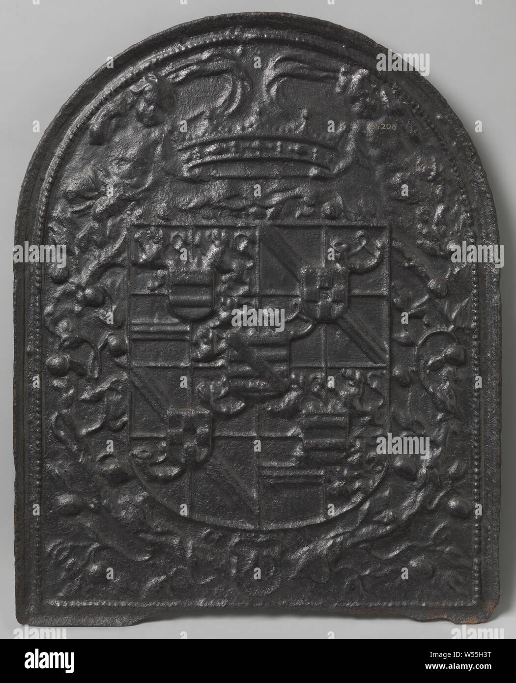 Fire plate with the arms of Maurits van Oranje, Fire plate made of cast iron, with a semicircular top. Central is the coat of arms of Maurits van Oranje. In addition to the crown, a putto flies on either side with a band with leaf vines and fruits, Maurits (Prince of Orange), anonymous, Germany, after c. 1618 - before c. 1625, iron (metal), founding, h 72.0 cm × w 57.0 cm × w 26 kg Stock Photo