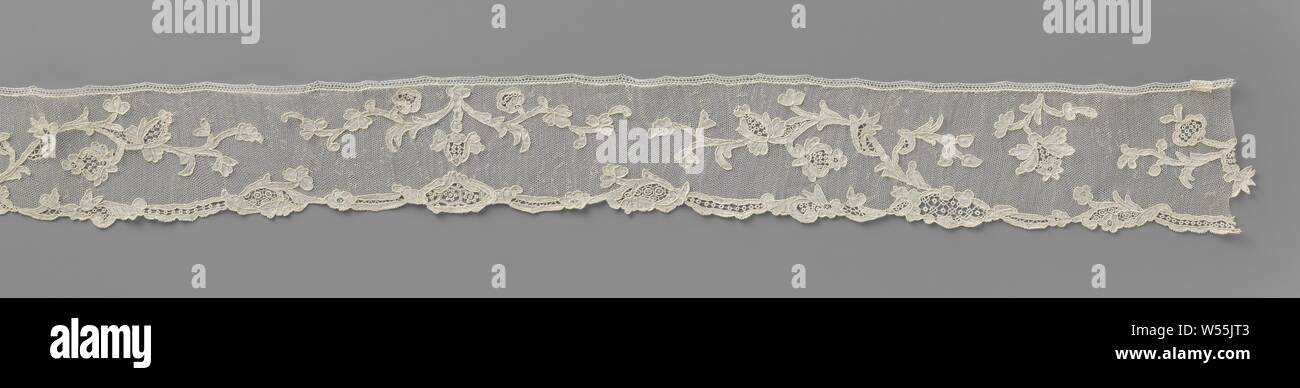 Strip of needle lace with hanging flowers, elongated shells of a wavy ribbon, interspersed with medallions with gridwork, form the outer edges of a ground, on which alternately a wavy branch with hanging flowers and pomegranates and a short flower sprig. The pattern in the strip is symmetrical with respect to a standing center branch. Alençon side., anonymous, France, c. 1760 - c. 1790, linen (material), Alençon lace, l 84 cm × w 8 cm ×, 43 cm Stock Photo