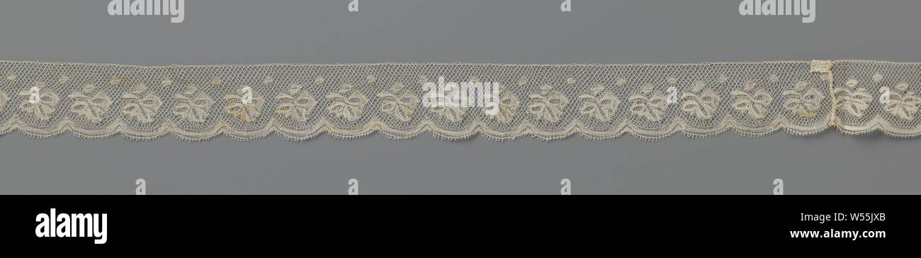 Strip of spool lace with hanging triple leaf, Strip of natural spool of lace: Valenciennes lace. On a square lattice there is a hanging vine leaf with berry on top of a smooth scallop., anonymous, Netherlands (possibly), c. 1930, linen (material), Valenciennes lace, l 320 cm × w 5 cm ×, 3 cm Stock Photo